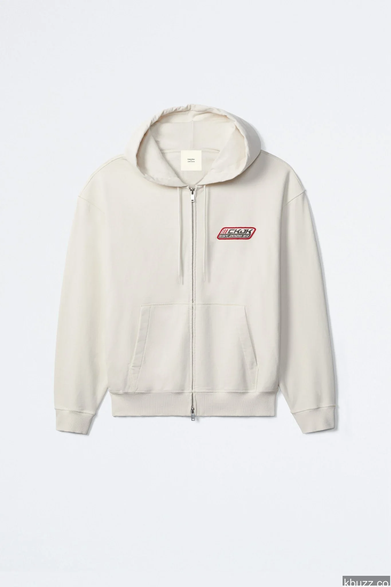 Off-white zip hoodie with a red CKJK EST. 2026 racing patch on the chest